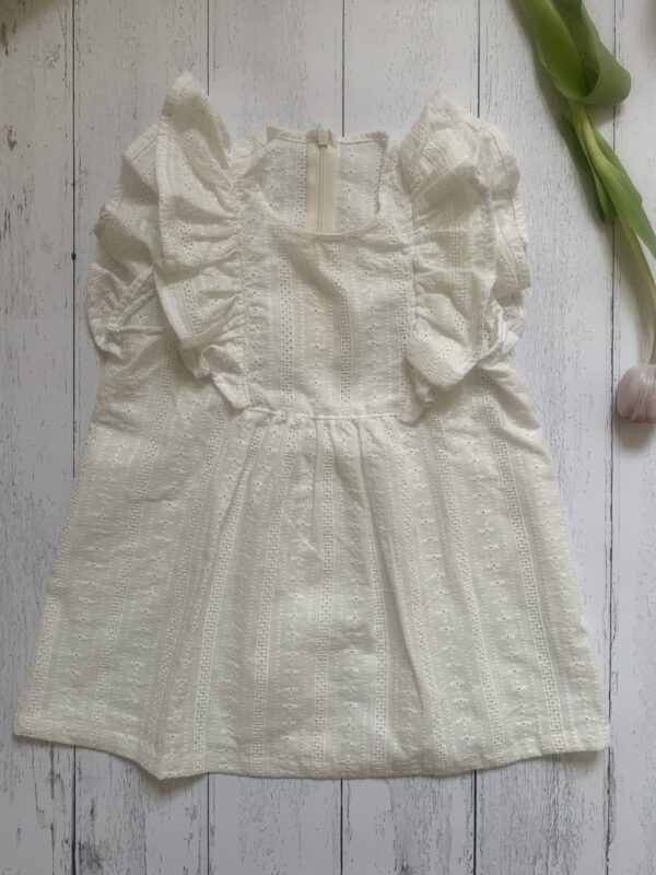Maglia color écru bambina con girocollo- smanicata con grande rouches , in tessuto di cotone 100% san gallo certificato BCI
