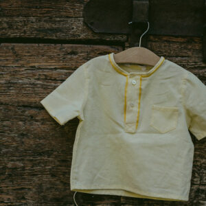 Maglia in cotone morbidissimo giallo, girocollo con dettaglio profilo e manica corta. Tessuto certificato cotone GRS (Global recycled standard)